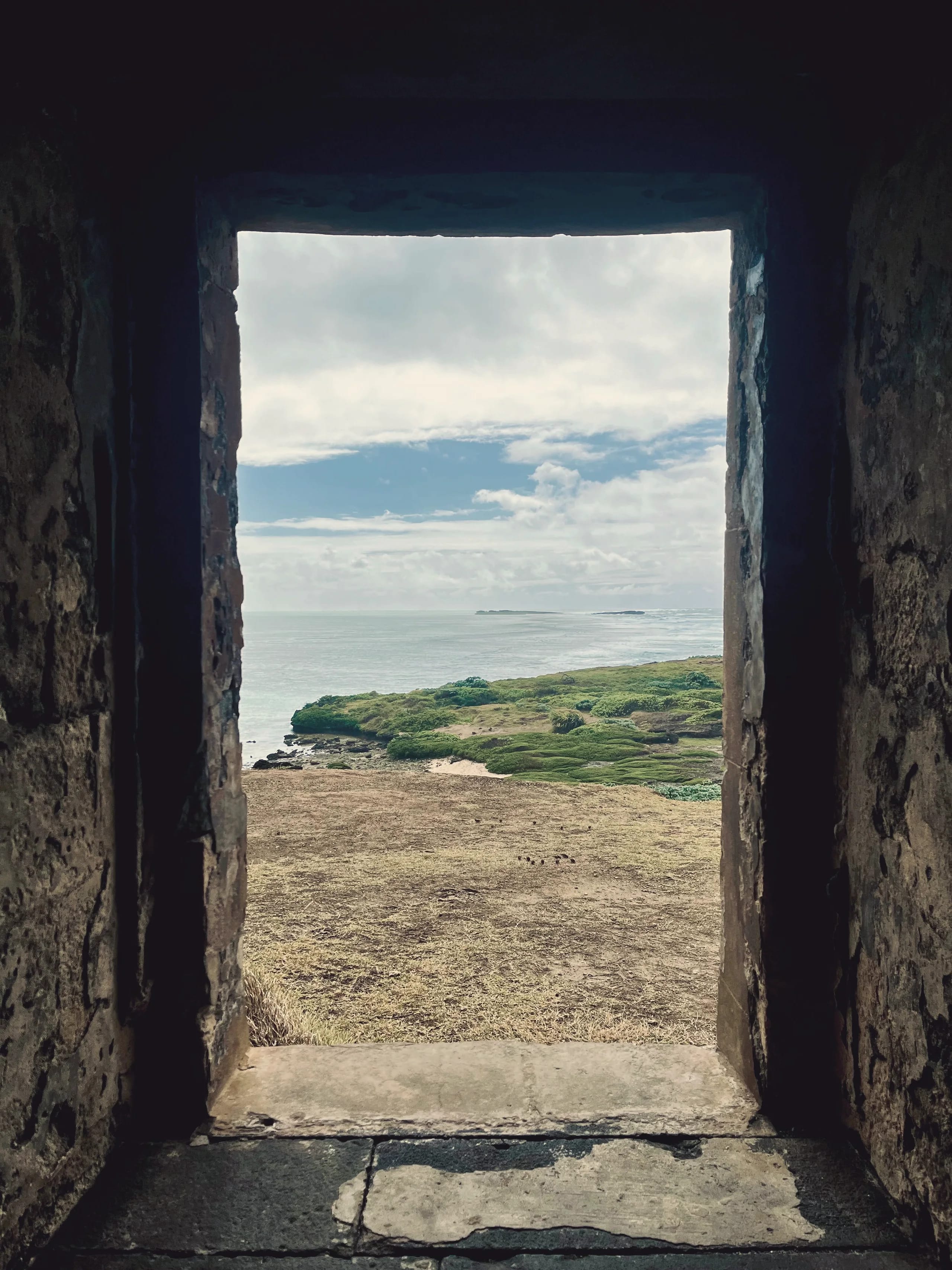 Coastal view through a historic fort window, north-west Mauritius